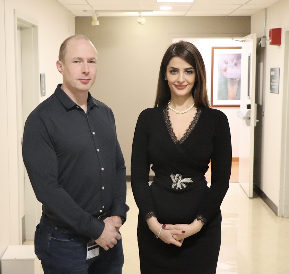 Dr. Sima Mofakham and Dr. Chuck Mikell standing in a research hallway at Stony Brook Medicine.